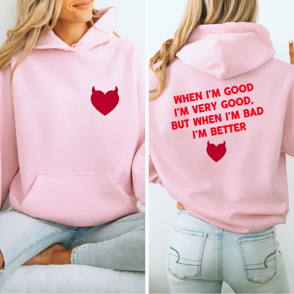 Devilish Hoodie – Light Pink Pullover with Red Heart & Bold Graphic Text